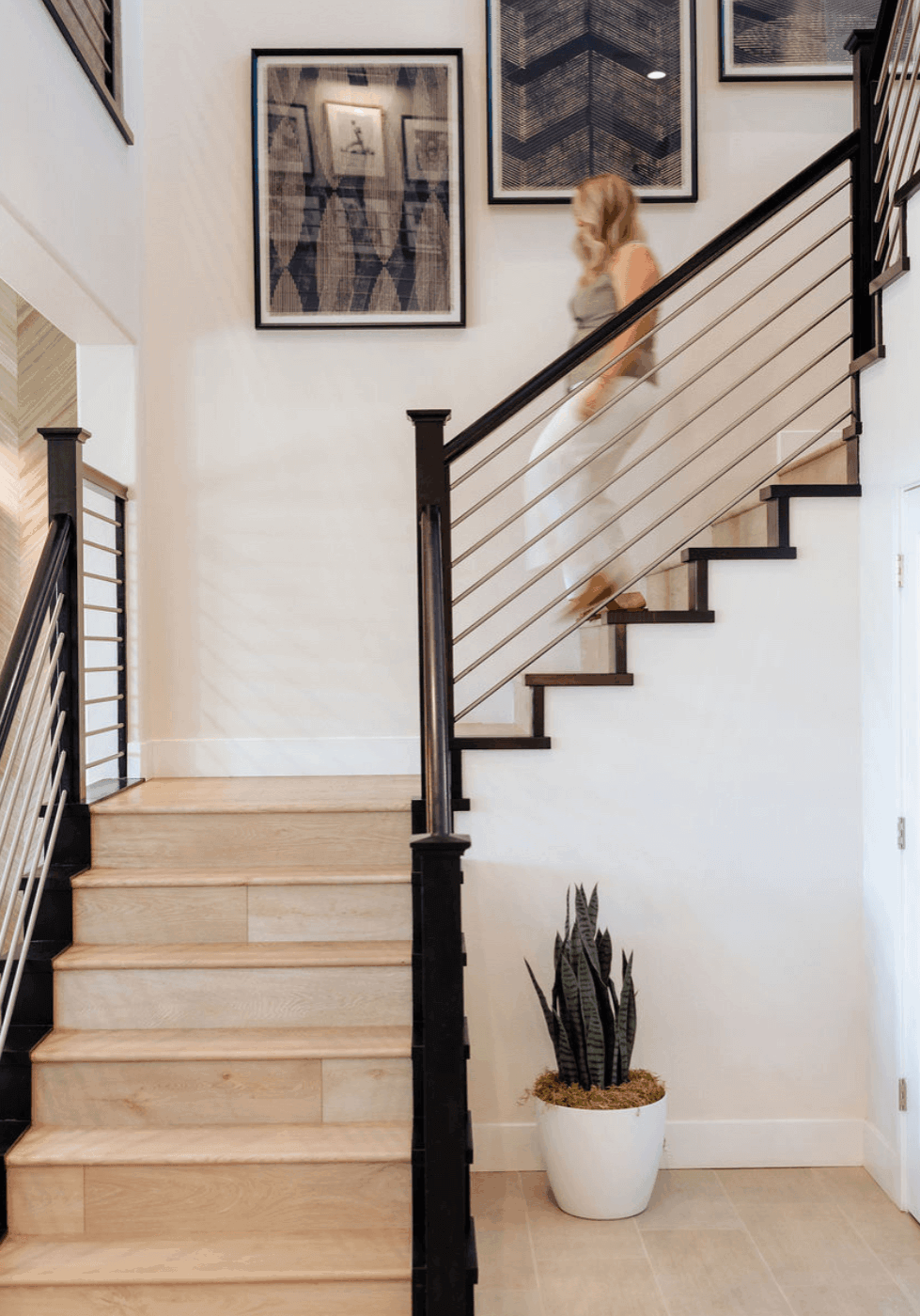 alyssa abbott walking down stairs for content marketing for luxury home brands